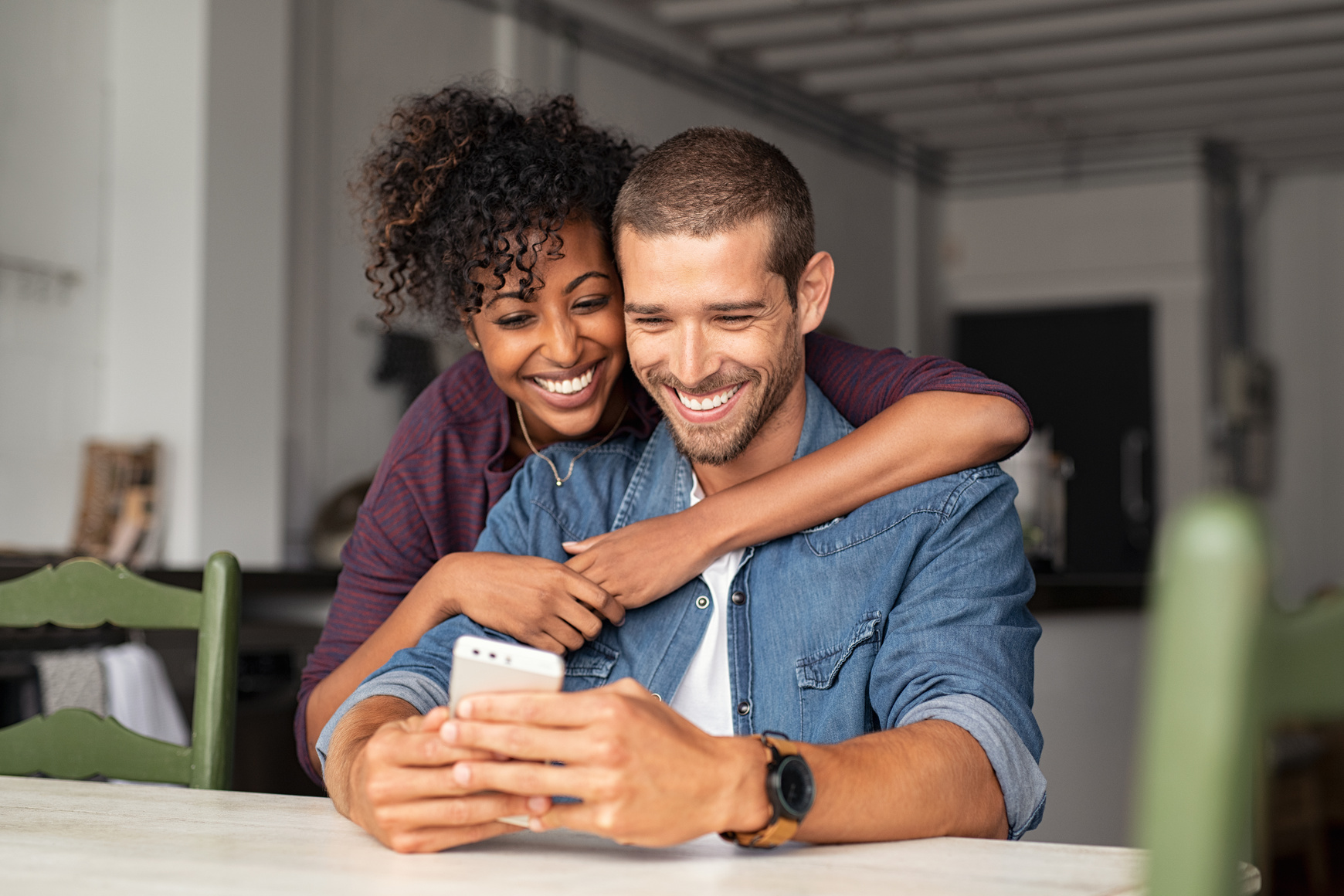 Happy couple looking at phone together